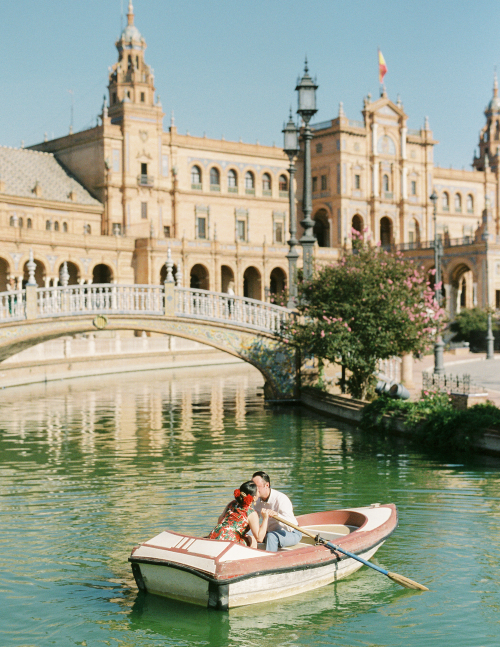 Engagement photo session in a historic Seville  square by film wedding photographer Olya Kobruseva