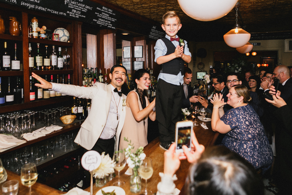 Bride, groom and excited guests enjoying their dinner and celebration at Sweetwater restaurant. Brooklyn NY