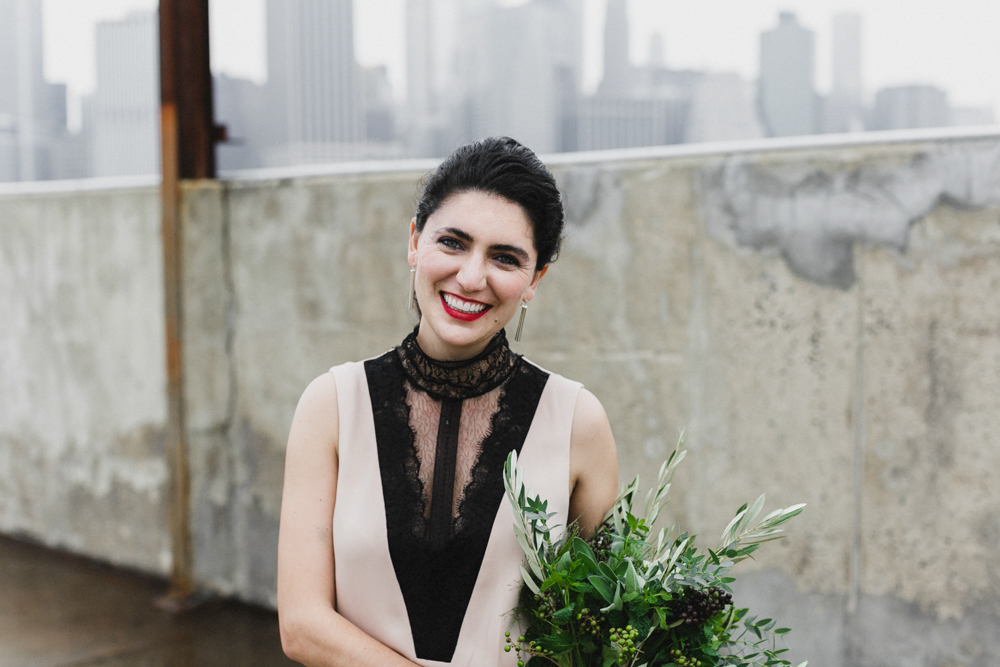 Excited bride on her wedding day with Manhattan skyline in the background.