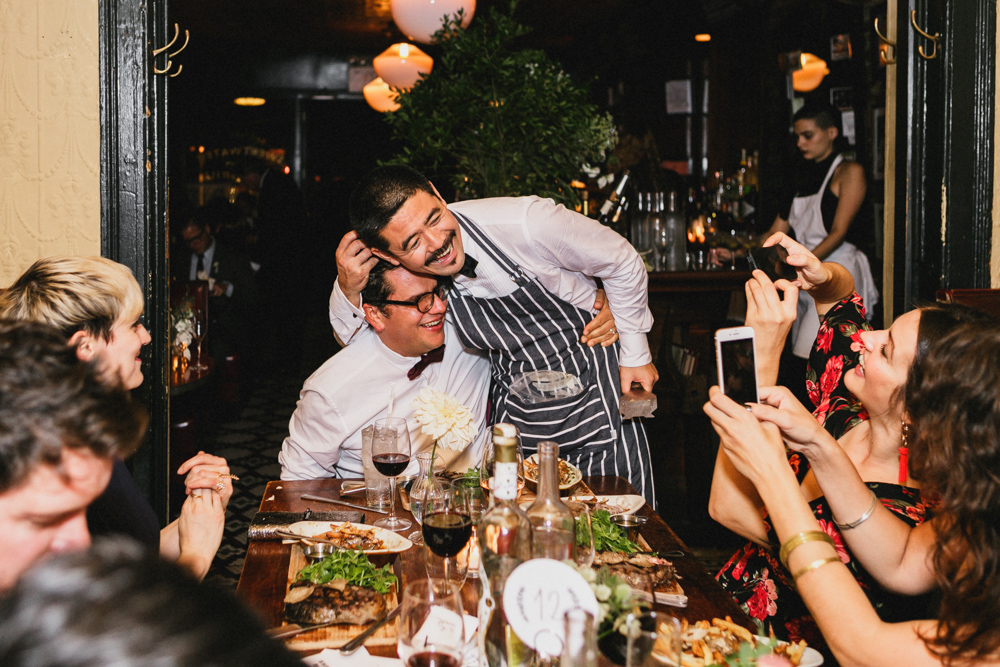 Happy groom making food for guests at Sweetwater restaurant Brooklyn NY