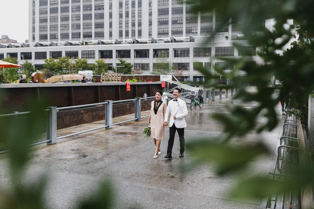 Happy bride and groom walking on a pier in Brooklyn NY