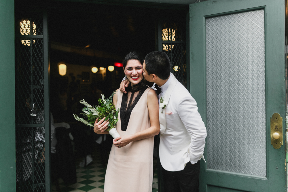 Excited bride and groom kissing on their wedding day in Brooklyn NY