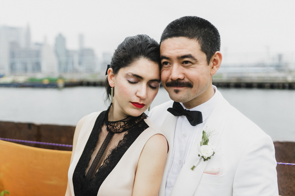Elegant bride and groom on their wedding day at a pier in Brooklyn NY