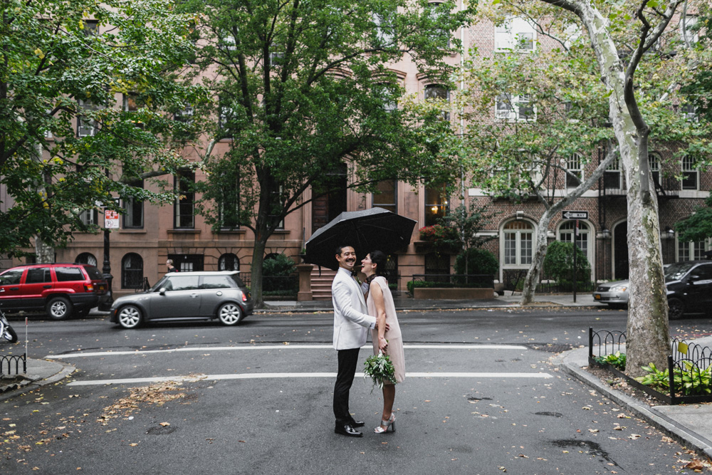 Couple laughing in the middle of the street with an umbrella, Brooklyn Heights, Brooklyn NY