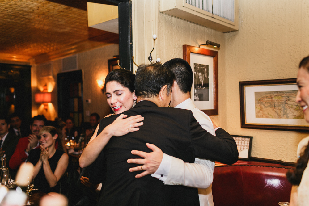 Bride and groom listening to their friends sharing wedding speeches at Sweetwater restaurant in Brooklyn NY