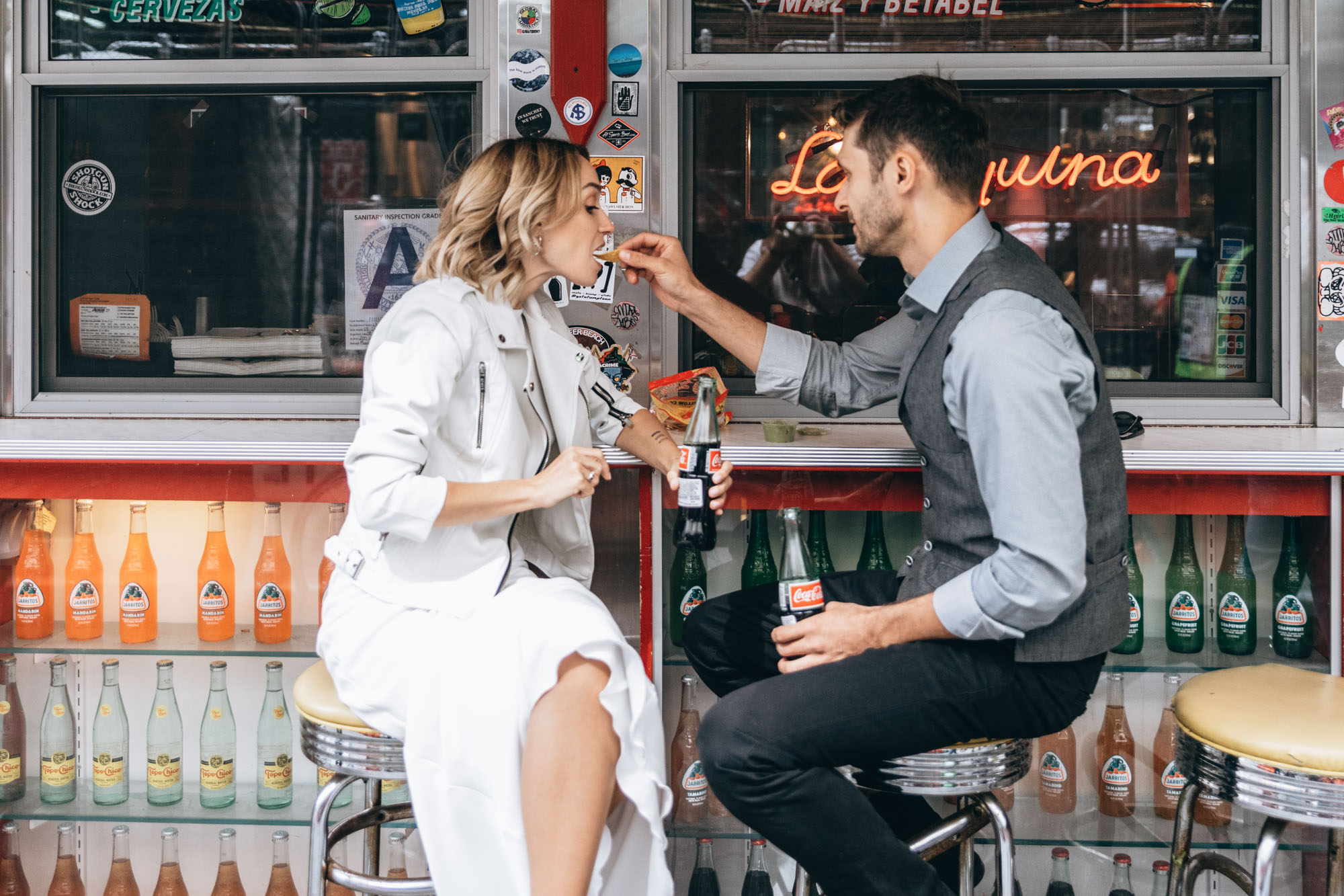 Bride and groom getting a snack on their wedding day in Manhattan, NYC