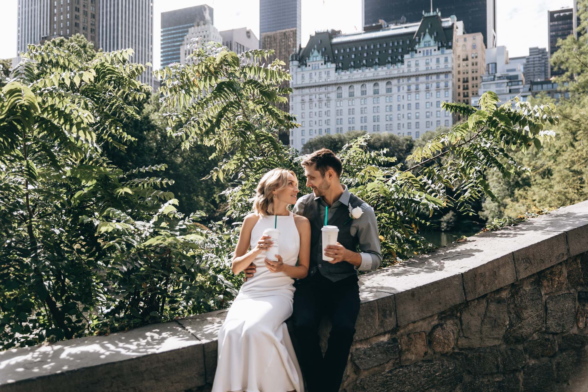 Bride and groom celebrate with drinks after their elopement ceremony in Central Park, Manhattan, NY
