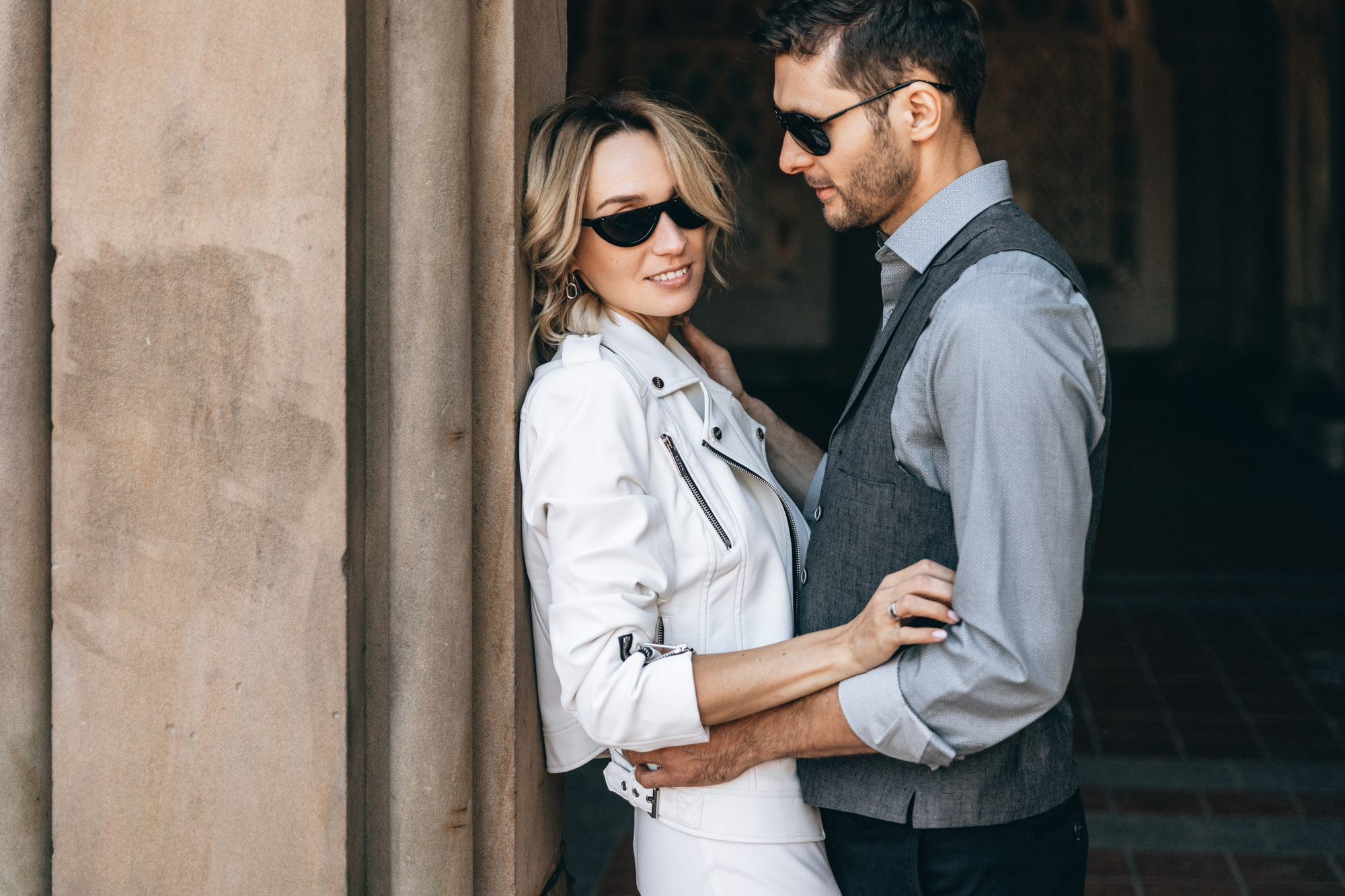 Bride and groom in sunglasses standing in Central Park on their wedding day, Manhattan