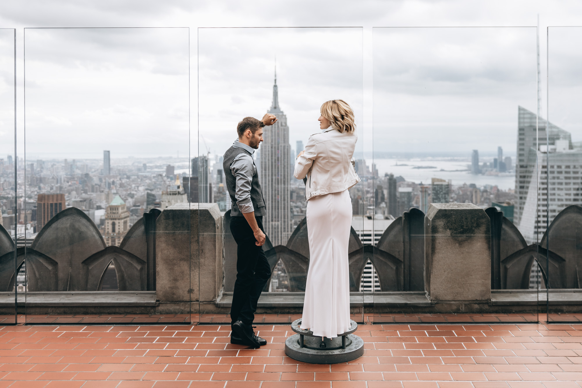 Bride and groom standing at Top of the Rock in Manhattan on their wedding day. NYC