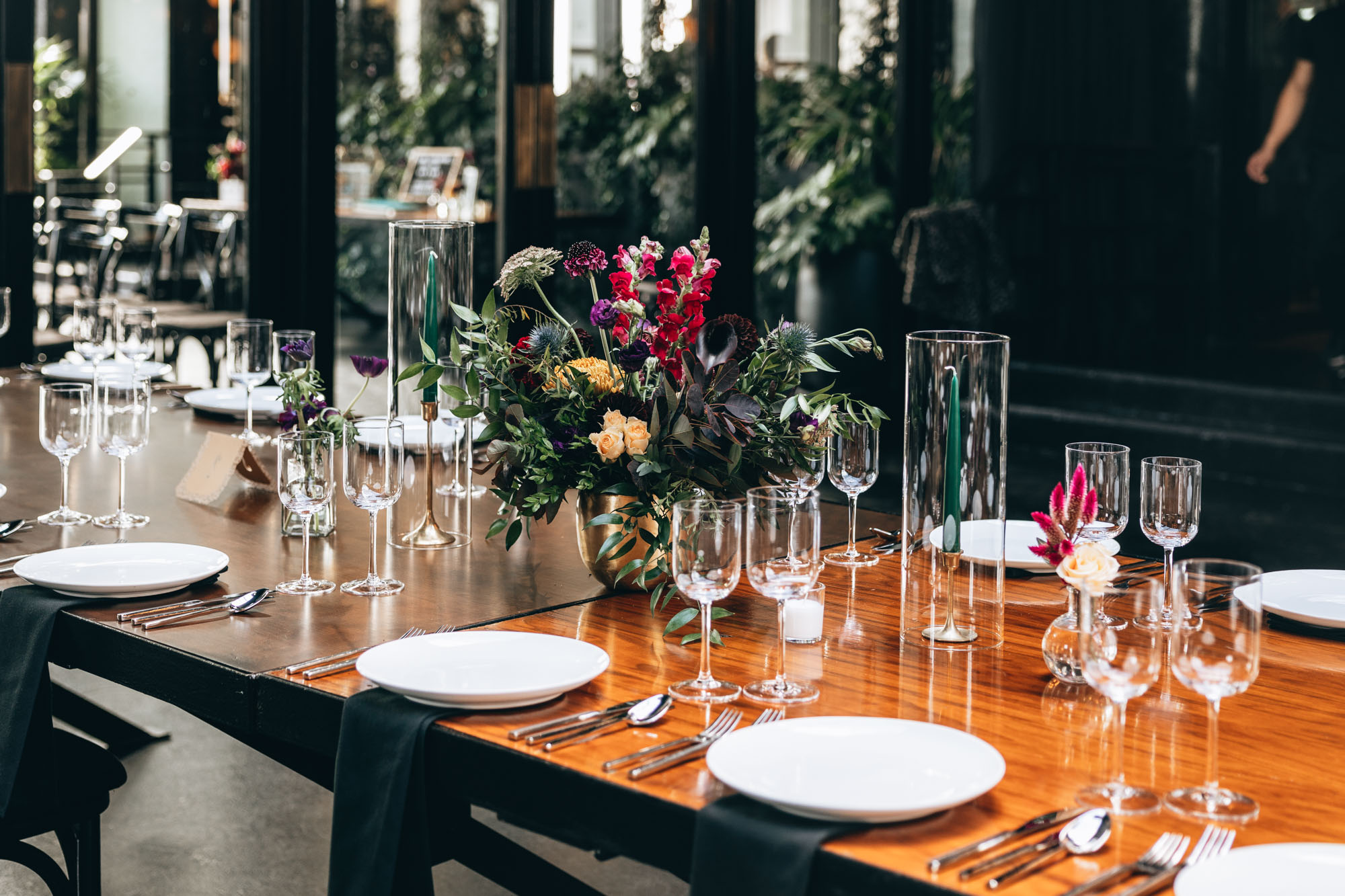 Dark and bold tables with floral centerpieces at a wedding in 501 Union, Brooklyn, NY