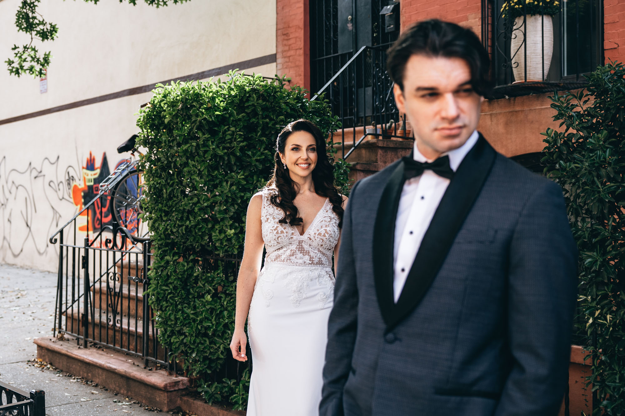 Bride walking to from a brownstone to the first look with her soon to be husband. Brooklyn, NY