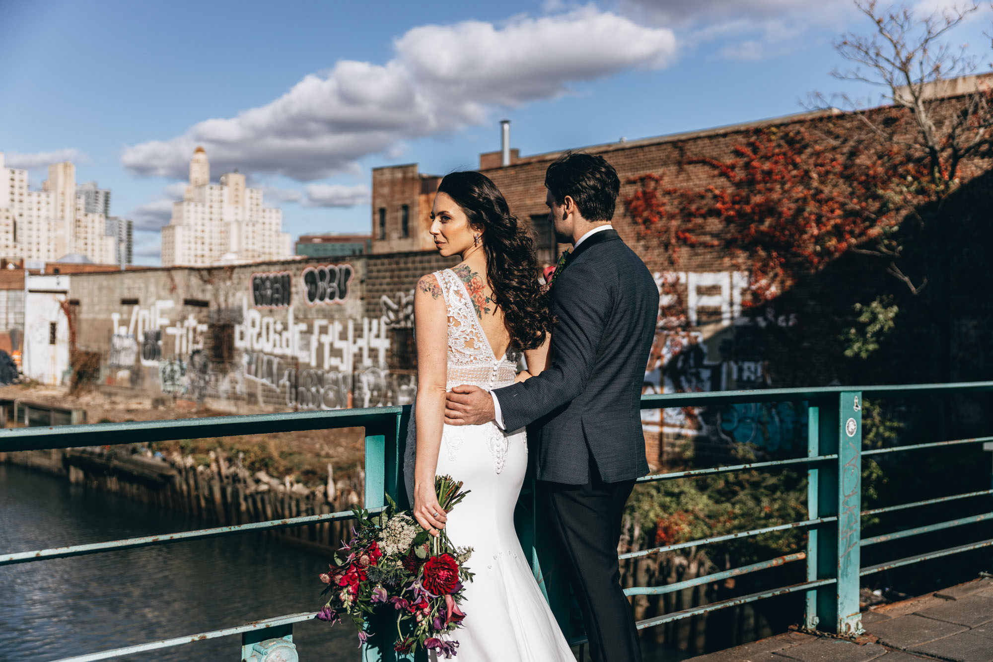 Bride and groom kissing with an industrial background, Brooklyn NY