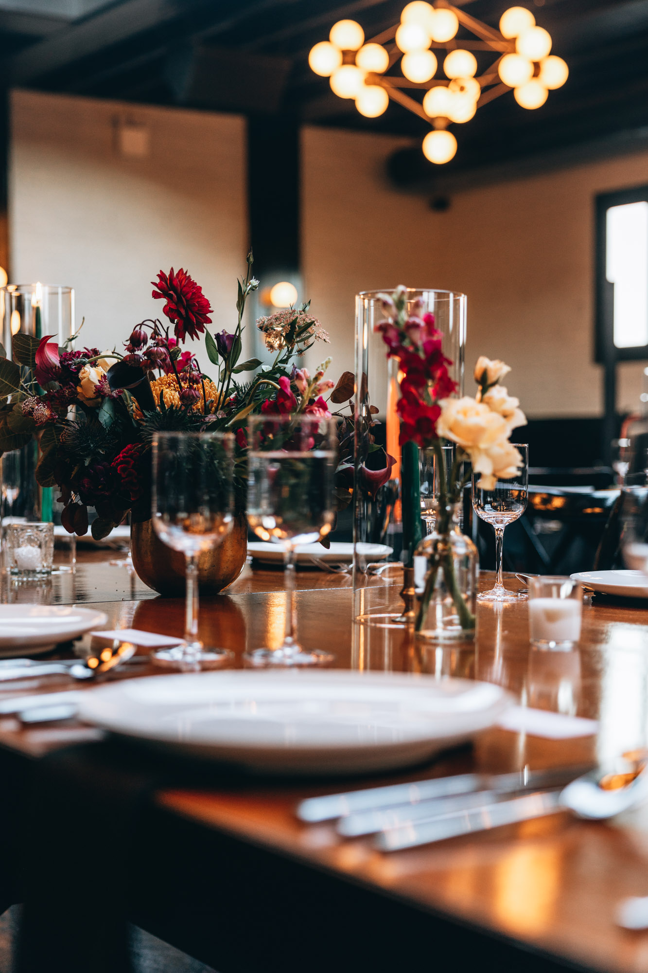 Dark and bold tables with floral centerpieces at a wedding in 501 Union, Brooklyn, NY