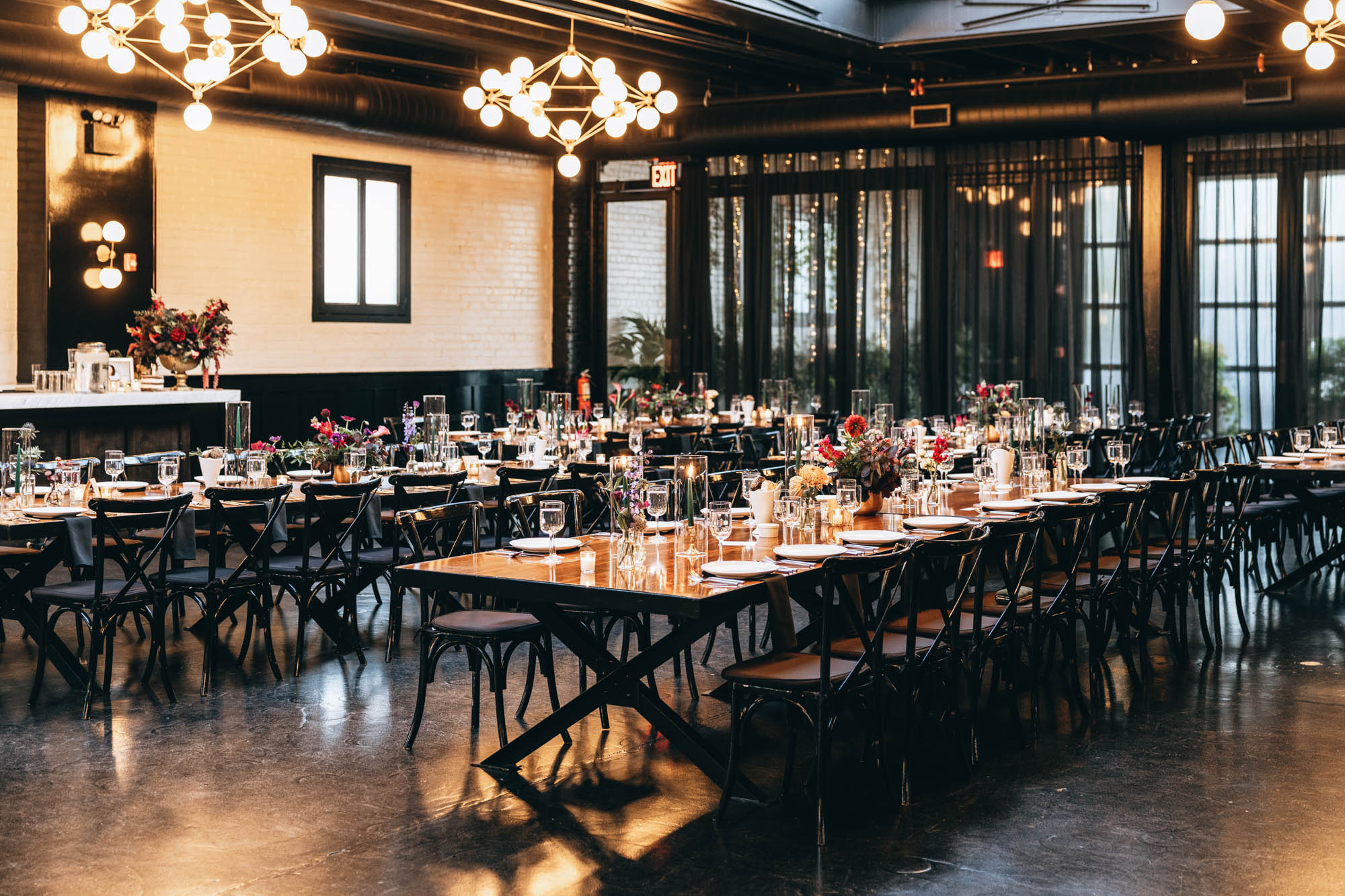 Dark and bold tables with floral centerpieces at a wedding in 501 Union, Brooklyn, NY