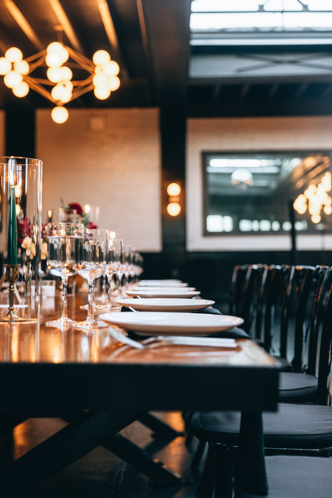 Dark and bold tables with floral centerpieces at a wedding in 501 Union, Brooklyn, NY