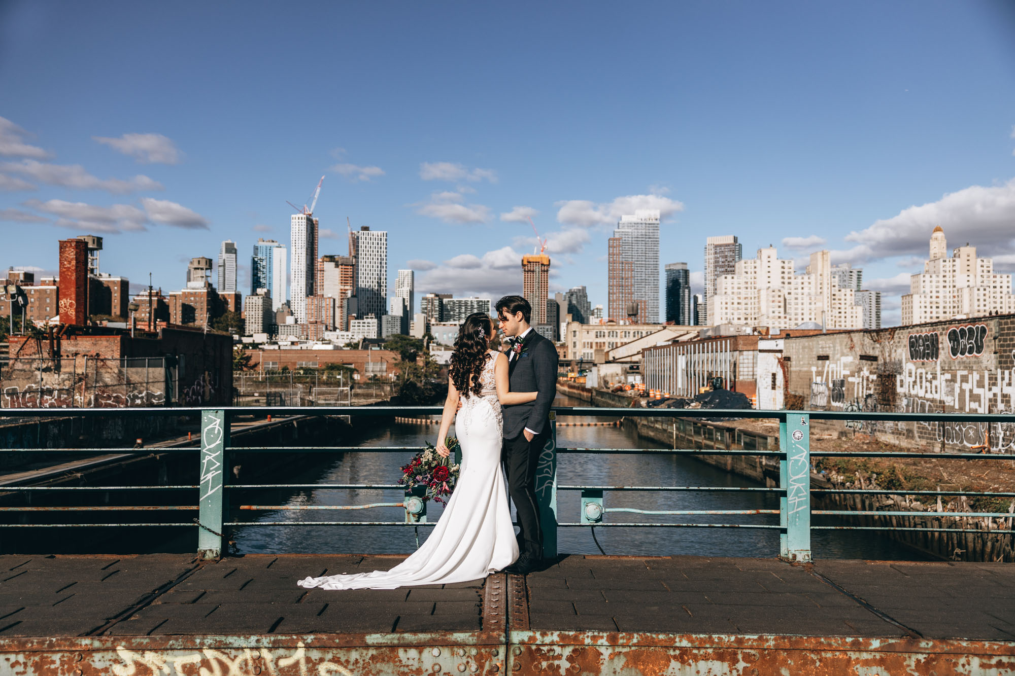 Bride and groom kissing with an industrial background, Brooklyn NY