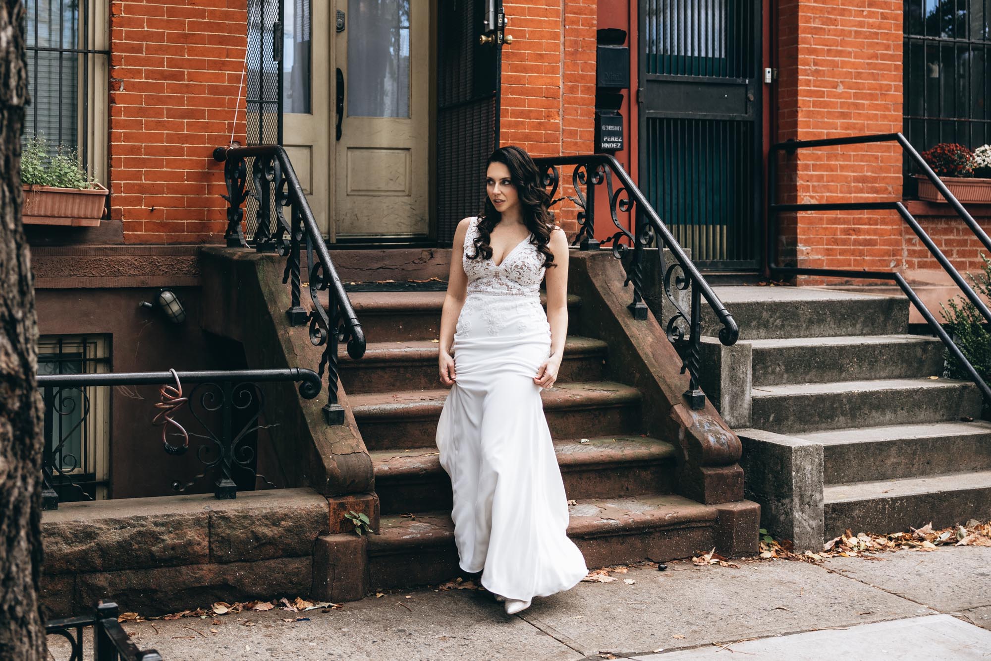 Bride walking to from a brownstone to the first look with her soon to be husband. Brooklyn, NY