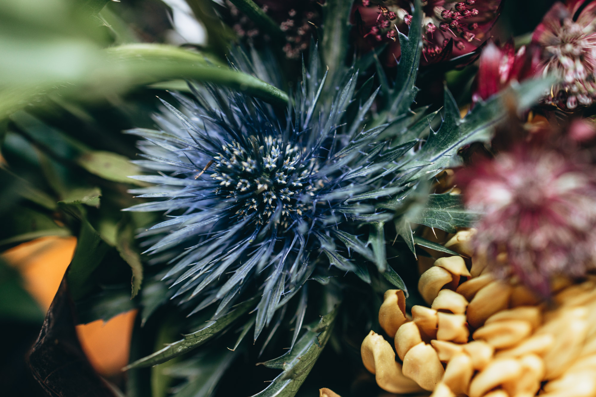 Dark and bold tables with floral centerpieces close up at a wedding in 501 Union, Brooklyn, NY