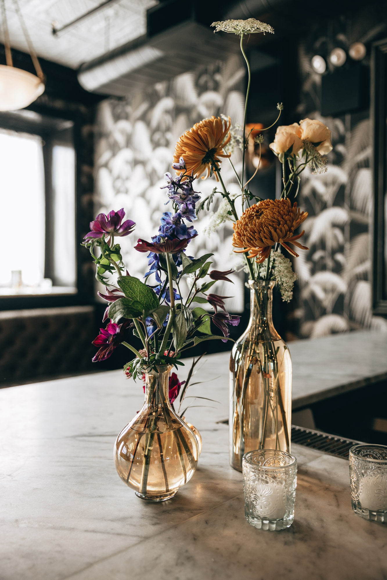 Dark and bold tables with floral centerpieces at a wedding in 501 Union, Brooklyn, NY