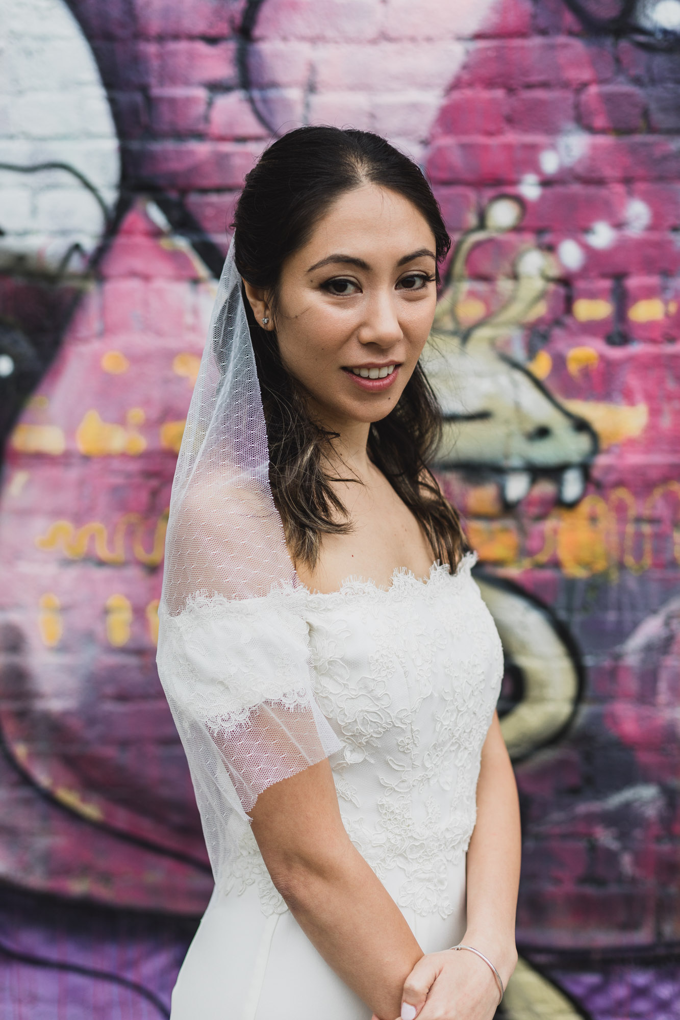 Portrait of the bride with amazing mural on the background.  Wedding in Williamsburg, Brooklyn