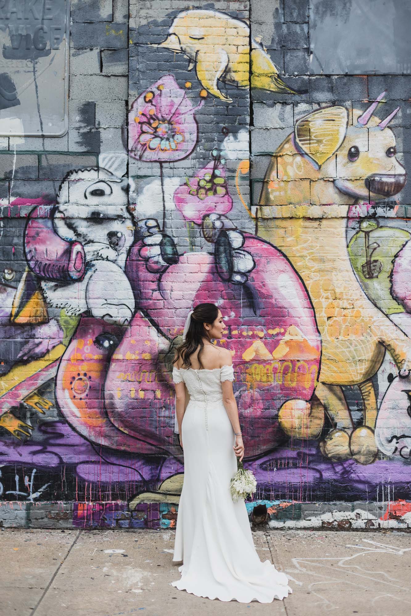 Portrait of the bride with amazing mural on the background.  Wedding in Williamsburg, Brooklyn
