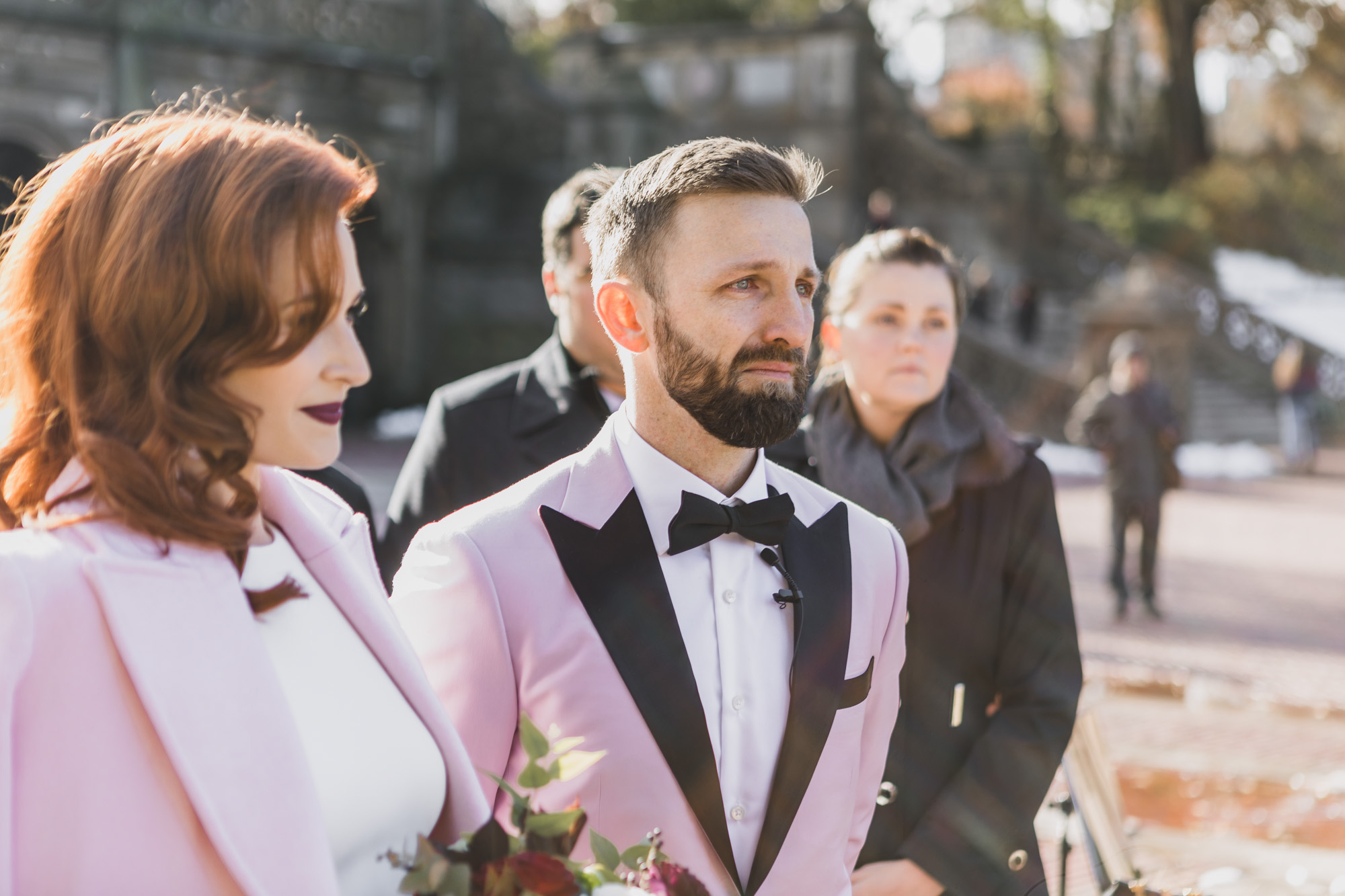 Emotional Aussie bride and groom in light pink outfits during their elopement ceremony. Bethesda Fountain and Terrace, Central Park. Manhattan, NY