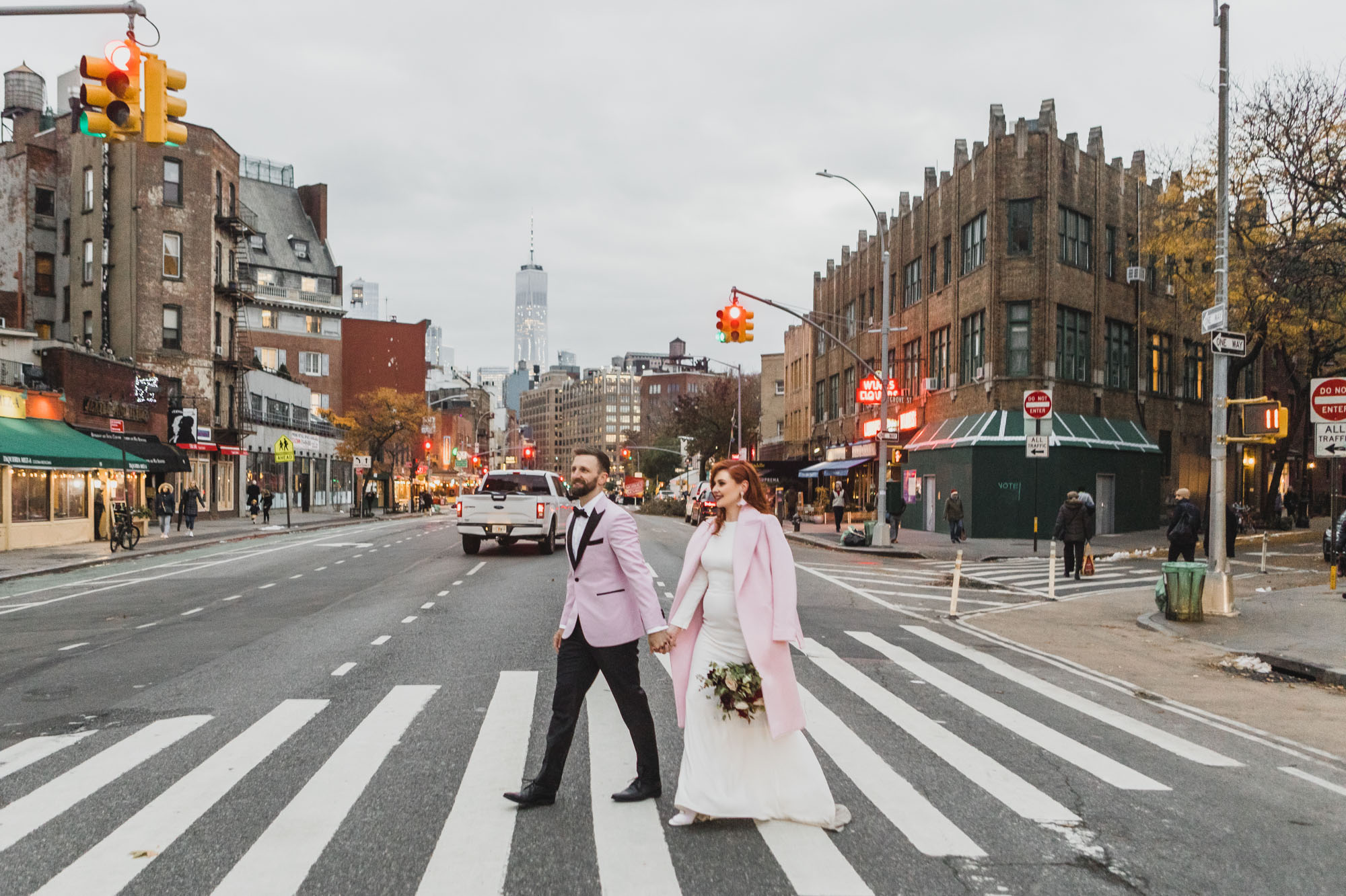 Aussie bride and groom in light pink outfits crossing the street in West Village, Manhattan NY