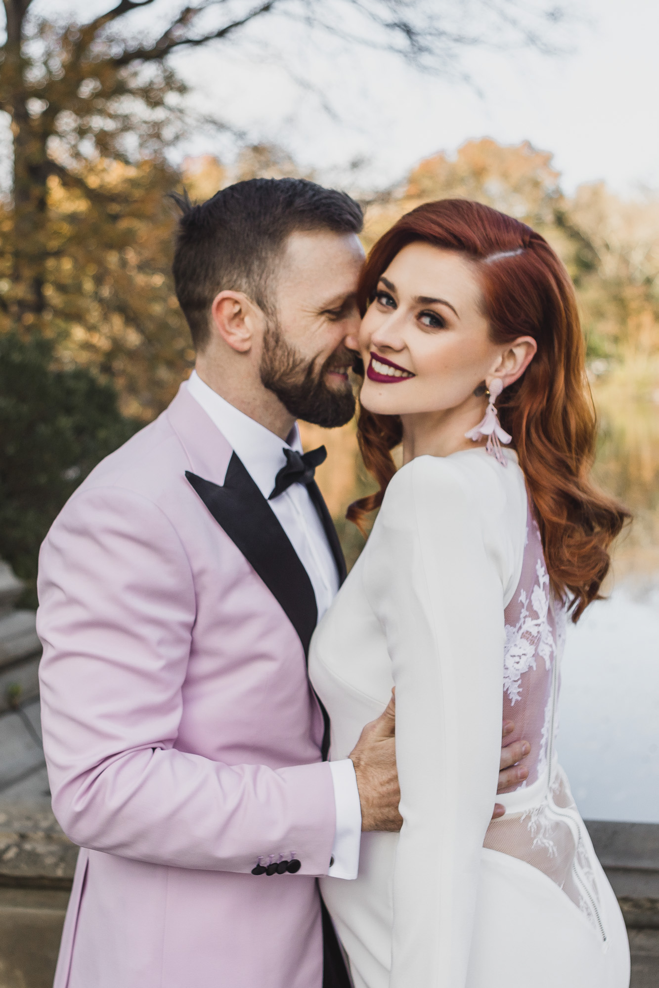 Happy Aussie bride and groom in light pink outfits during their elopement at Bethesda Fountain and Terrace, Central Park. Manhattan, NY