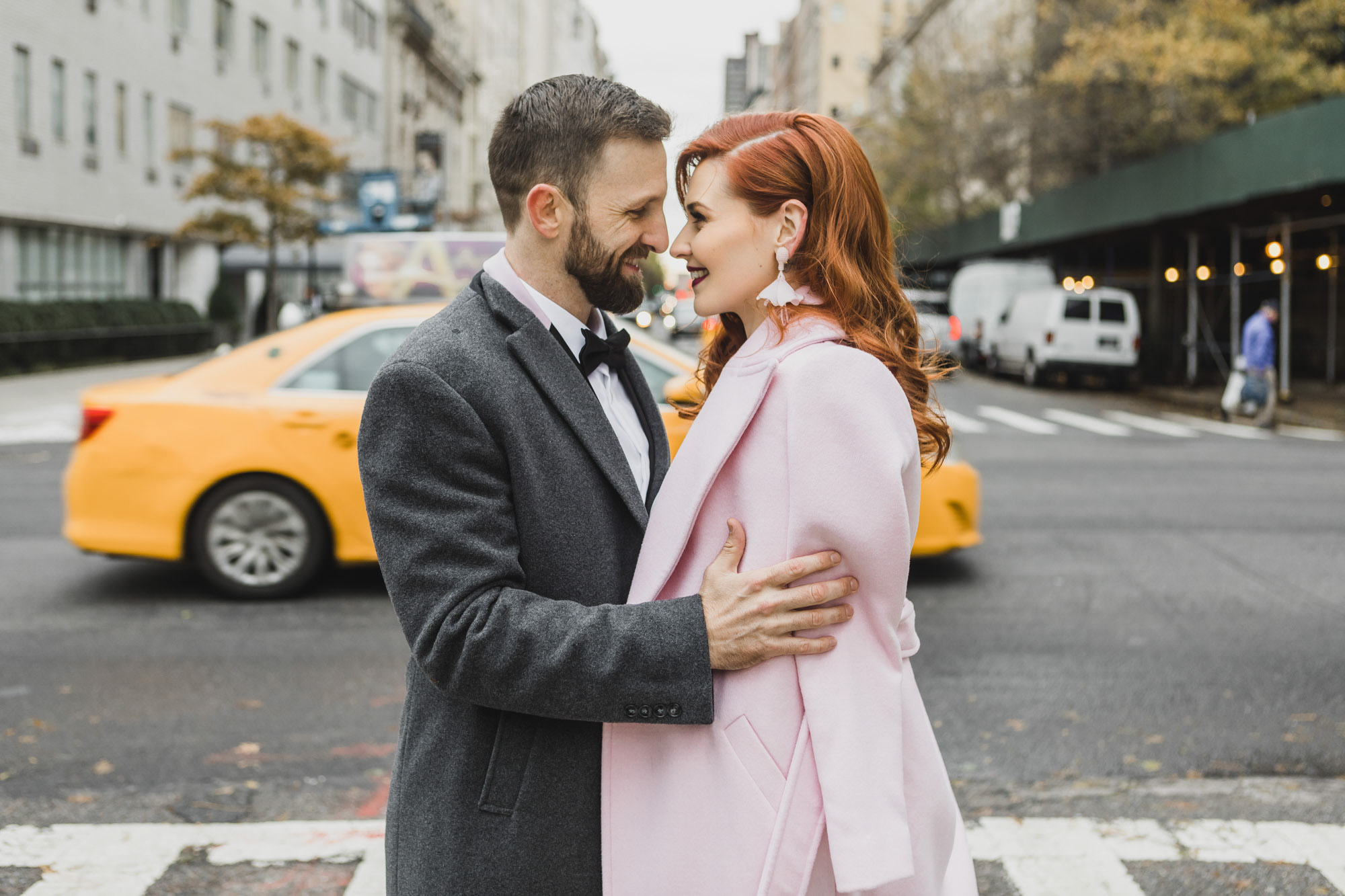Happy bride and groom with. yellow cab in the back. Manhattan NY