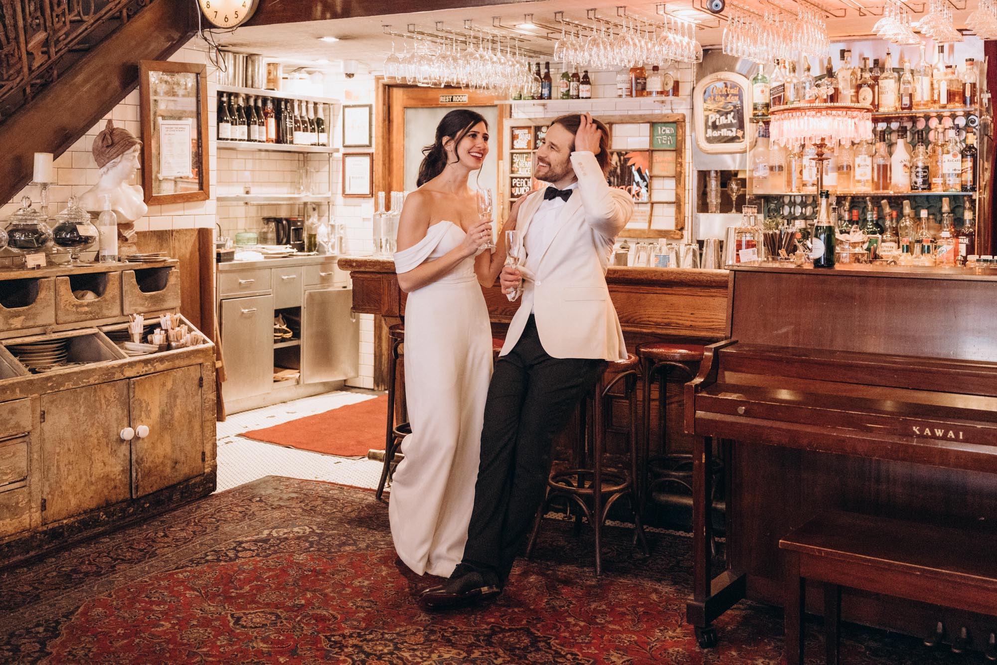 Bride and groom celebrate with drinks after their elopement wedding. Soho,  Manhattan, NY