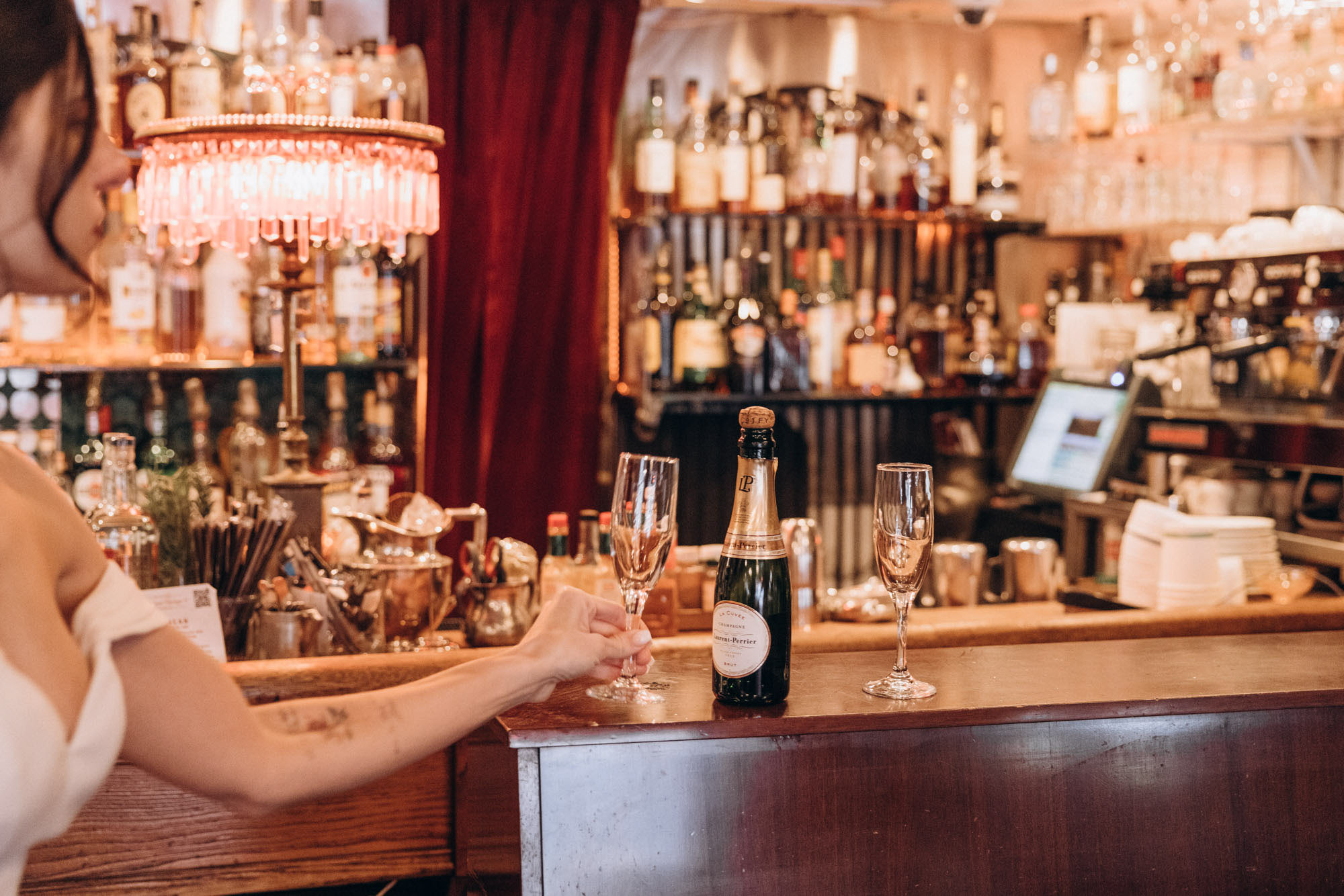 Bride getting a drink to celebrate the elopement. Soho. Manhattan NY