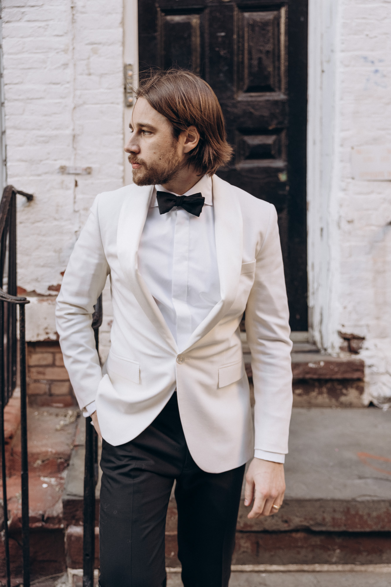 Stylish groom in a white suit during his winter NYC elopement. 