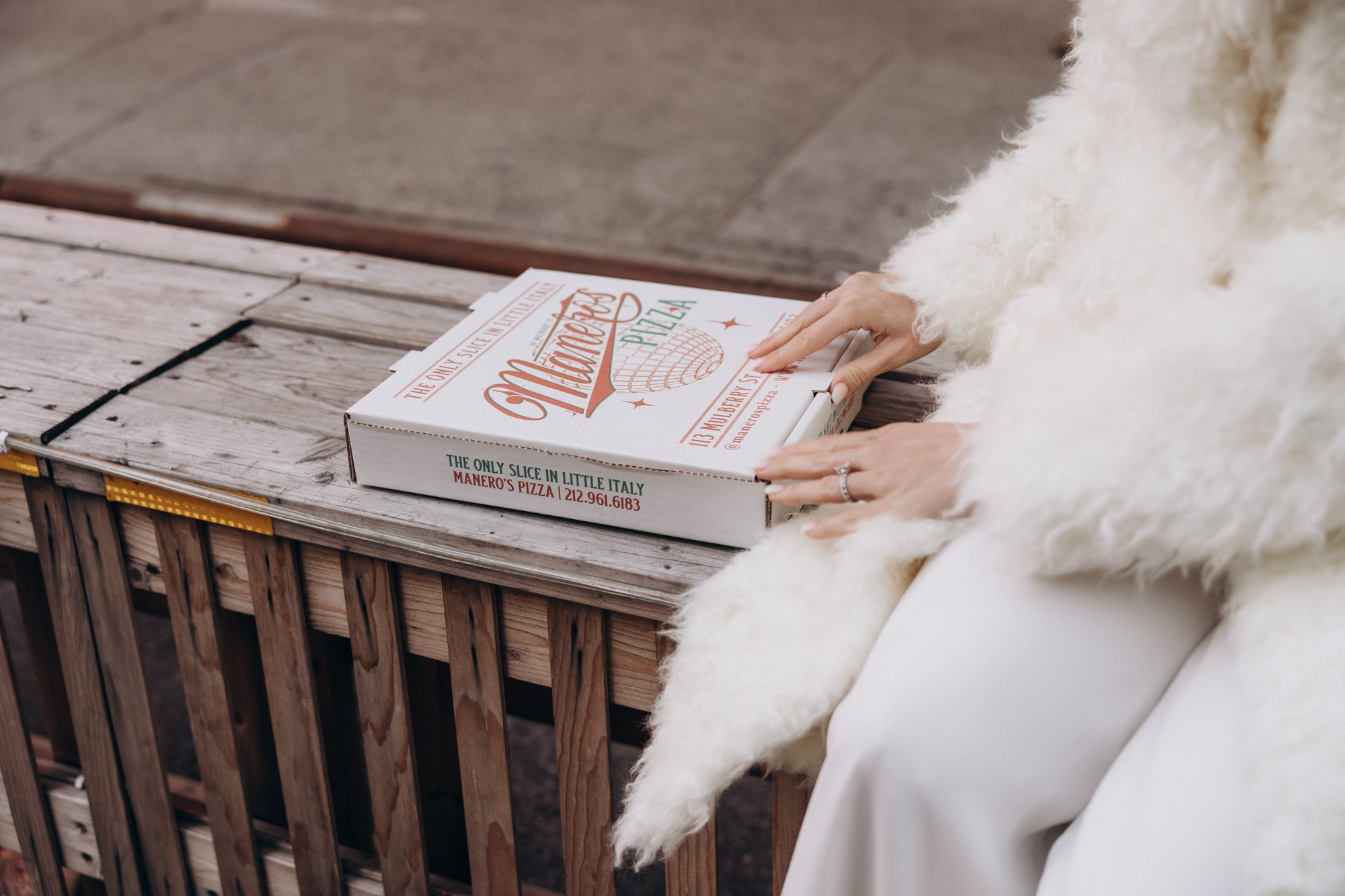 Bride and her pizza. Winter elopement. Little Italy, Manhattan NY