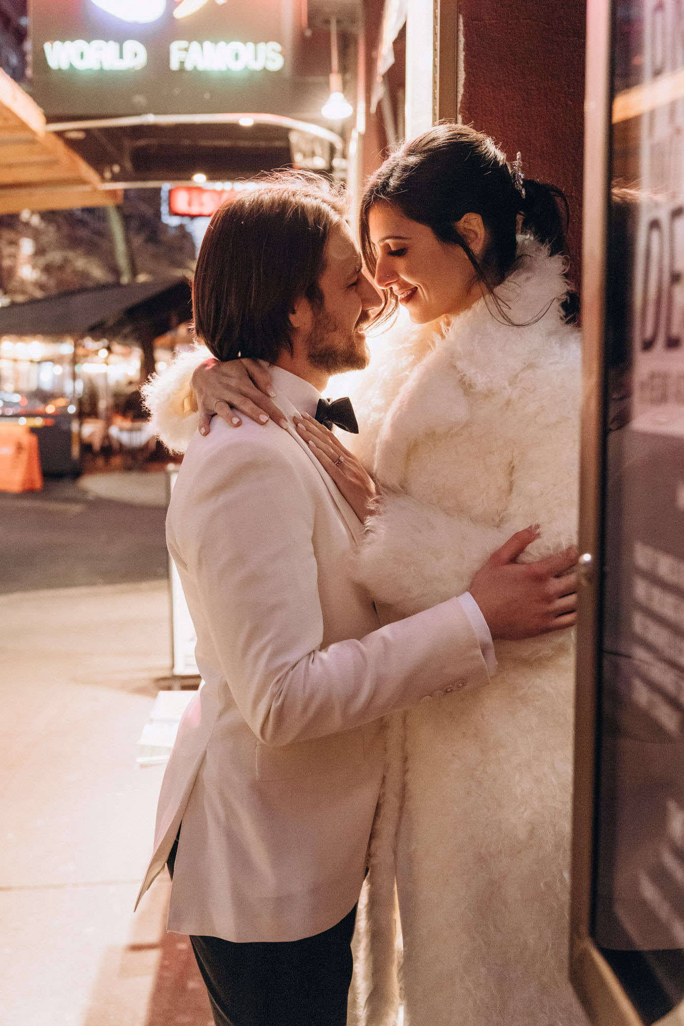 Stylish bride and groom walking in a fuzzy fur coat in the West Village. Manhattan NY