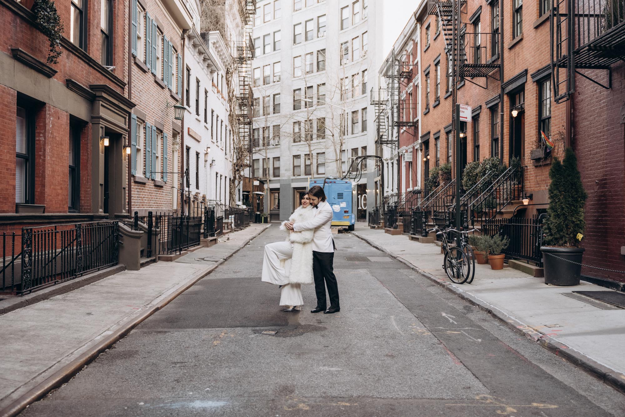Stylish bride and groom walking in a fuzzy fur coat in the West Village. Manhattan NY