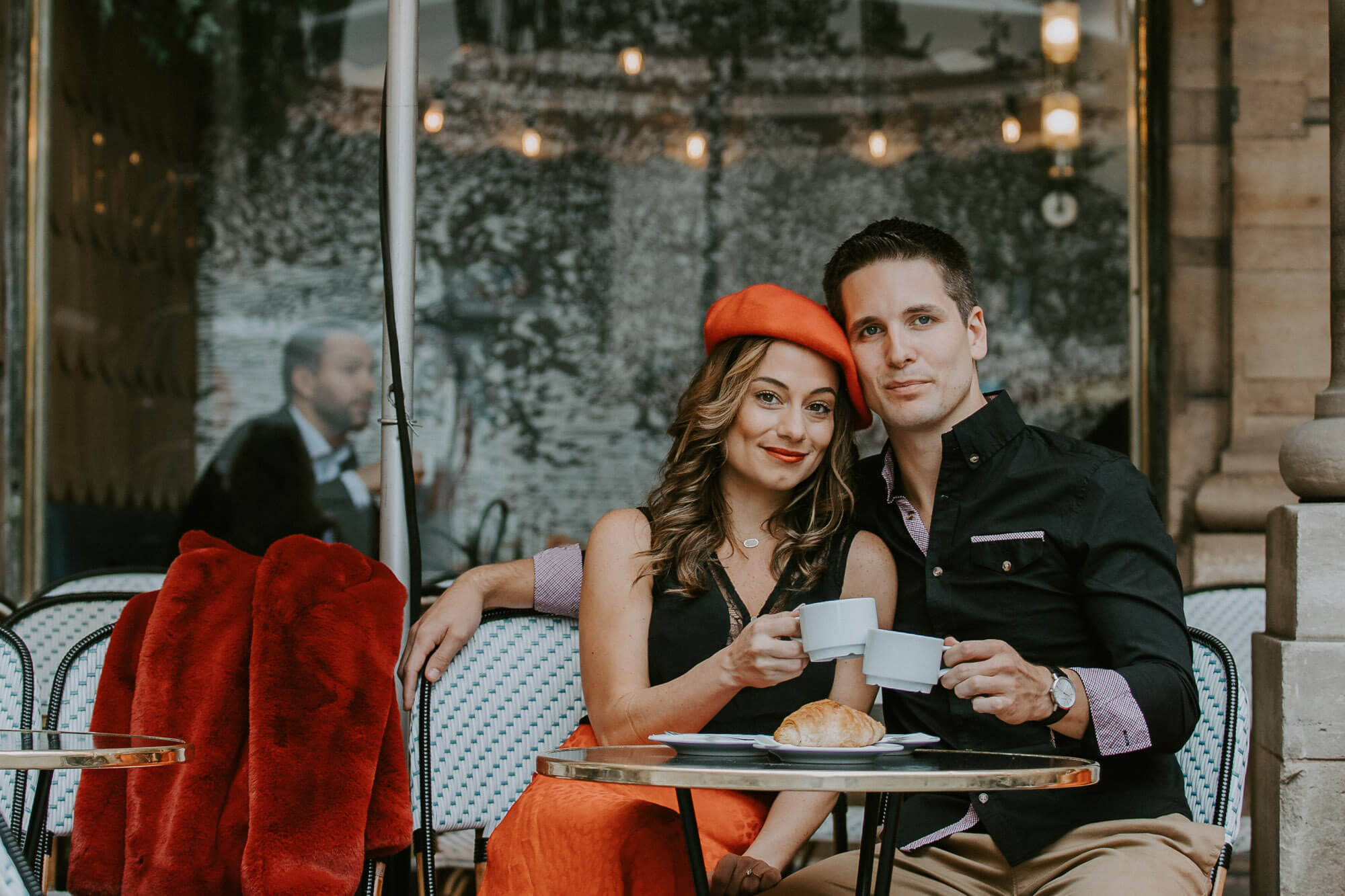 Elopement photoshoot in Paris - Beautiful couple stylishly dressed at the Parisian cafe terrasse