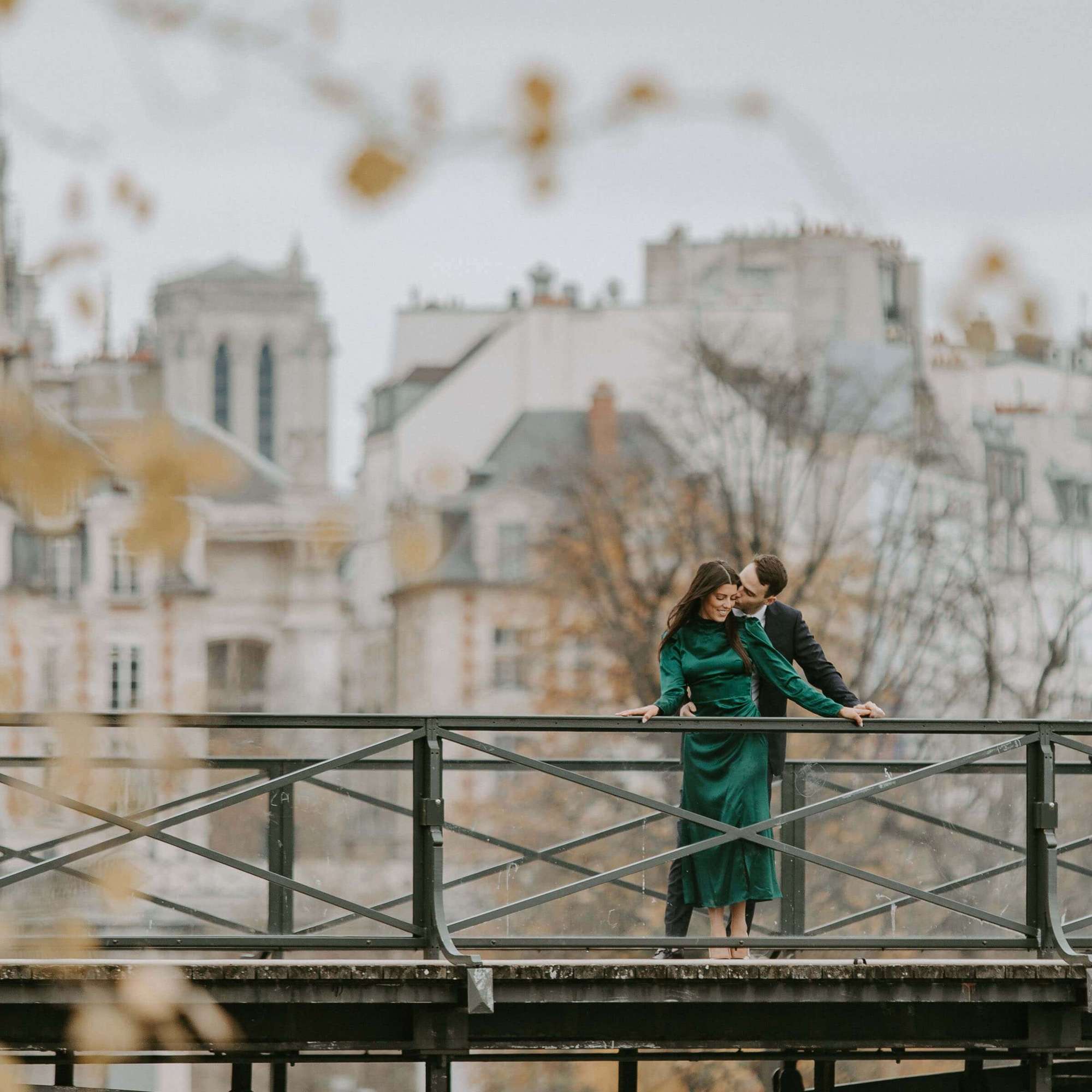 Elopement photography Paris - Tenderly embracing couple on the Pont des Arts in Paris. photo by PhilArty